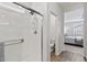 Bright and airy bathroom featuring a glass-enclosed shower with view of bedroom at 14601 W Valentine St, Surprise, AZ 85379