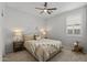 Cozy bedroom with ceiling fan and plush carpet is illuminated by bedside lamps at 14601 W Valentine St, Surprise, AZ 85379