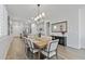 Bright dining room features wood floors, a stylish light fixture and is adjacent to the kitchen at 14601 W Valentine St, Surprise, AZ 85379