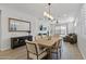 Dining room with wood floors and modern lighting extends into an open-concept living area at 14601 W Valentine St, Surprise, AZ 85379