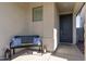 Covered entryway features a bench with decorative pillows and charming decor at 14601 W Valentine St, Surprise, AZ 85379