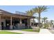 Firebirds Wood Fired Grill exterior featuring palm trees, modern design, and outdoor seating at 14601 W Valentine St, Surprise, AZ 85379