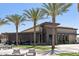 Firebirds Wood Fired Grill exterior showcasing modern architecture, palm trees, and outdoor seating at 14601 W Valentine St, Surprise, AZ 85379