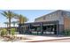Exterior view of Cold Beers & Cheeseburgers restaurant with outdoor seating and palm trees at 14601 W Valentine St, Surprise, AZ 85379