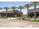 Restaurant exteriors with palm trees and outdoor seating areas create a welcoming street-side ambiance at 14601 W Valentine St, Surprise, AZ 85379