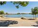 Scenic view of the lake, featuring a sandy beach and a fountain feature at 14601 W Valentine St, Surprise, AZ 85379