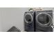 This laundry room offers a convenient space with modern washer and dryer units at 14601 W Valentine St, Surprise, AZ 85379