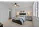 Inviting main bedroom features a ceiling fan and plenty of natural light from the window at 14601 W Valentine St, Surprise, AZ 85379