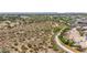 Aerial view showcasing neighborhood with desert landscape, streets, and houses; highlighting suburban living near open spaces at 16010 N 74Th Ln, Peoria, AZ 85382