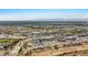 Expansive aerial view of Peoria's commercial district with highways and surrounding mountain ranges at 16010 N 74Th Ln, Peoria, AZ 85382