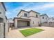 Wide backyard showing artificial turf, gravel landscaping, and a covered patio with sliding glass doors at 16010 N 74Th Ln, Peoria, AZ 85382