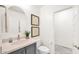 Powder room featuring modern fixtures, a vanity with storage, and decorative wall art at 16010 N 74Th Ln, Peoria, AZ 85382