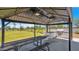A community grilling area with a shade structure, picnic table and grassy landscaping at 16010 N 74Th Ln, Peoria, AZ 85382