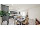 Bright dining area featuring a modern table, stylish chairs, and a view into the kitchen at 16010 N 74Th Ln, Peoria, AZ 85382