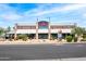 The building is an elegant design with a gray and white brick facade, and a sign in red letters at 16010 N 74Th Ln, Peoria, AZ 85382