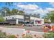 The building features a light exterior, black awning, and lush landscaping, enhancing the curbside appeal at 16010 N 74Th Ln, Peoria, AZ 85382