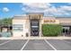The building features a modern facade with clean lines, a minimalist entrance, and lush green landscaping at 16010 N 74Th Ln, Peoria, AZ 85382