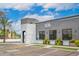 The building has a modern gray facade with black-framed windows, complemented by potted greenery and ample parking at 16010 N 74Th Ln, Peoria, AZ 85382