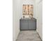Hallway with stylish gray cabinetry, countertop decor, neutral paint, and wood-look flooring, creating a cozy atmosphere at 16010 N 74Th Ln, Peoria, AZ 85382