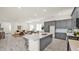 Open-concept kitchen and living area, featuring an island with bar seating at 16010 N 74Th Ln, Peoria, AZ 85382