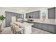 Modern kitchen with gray cabinets, quartz countertops, and stainless steel appliances at 16010 N 74Th Ln, Peoria, AZ 85382