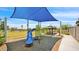 A community playground features a slide, shade structure, and grassy landscaping at 16010 N 74Th Ln, Peoria, AZ 85382