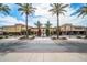 A shopping center entrance is framed by palm trees and manicured greenery creating an inviting atmosphere at 16010 N 74Th Ln, Peoria, AZ 85382