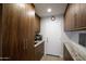 Hallway featuring sleek cabinetry, granite countertops, and a charming decorative touch with a wine rack at 17890 N 99Th Dr, Sun City, AZ 85373