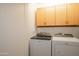 Laundry room equipped with a modern, matching Whirlpool washer and dryer set at 17890 N 99Th Dr, Sun City, AZ 85373