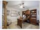 Well-appointed office with custom built-in shelving, a spacious desk, and ample natural light at 17890 N 99Th Dr, Sun City, AZ 85373