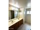 Bathroom with a double-sink vanity, tiled floors, and a shower at 1836 N Stapley Dr # 88, Mesa, AZ 85203