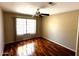 Cozy bedroom with hardwood floors, fan, and a bright window at 1836 N Stapley Dr # 88, Mesa, AZ 85203