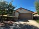 Inviting single-story home featuring a neutral color palette, a two-car garage and a well-maintained front yard at 1836 N Stapley Dr # 88, Mesa, AZ 85203
