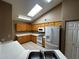 Bright kitchen with ample wood cabinets, white countertops, and modern appliances at 1836 N Stapley Dr # 88, Mesa, AZ 85203