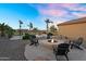 Relaxing backyard space with fire pit and Adirondack chairs at 18822 E Flintlock Dr, Queen Creek, AZ 85142