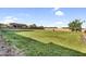 Large backyard with sprawling grass, ideal for recreation and relaxation, offering ample space for outdoor enjoyment at 18822 E Flintlock Dr, Queen Creek, AZ 85142