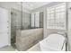 Modern bathroom with glass shower and freestanding tub with natural light at 18822 E Flintlock Dr, Queen Creek, AZ 85142