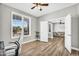 Inviting bedroom with wood flooring, a ceiling fan, white trim, and a window with shutter blinds at 18822 E Flintlock Dr, Queen Creek, AZ 85142