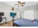Bright bedroom with a ceiling fan, a TV, and a large closet for storage at 18822 E Flintlock Dr, Queen Creek, AZ 85142
