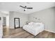 Neutral bedroom features wood floors, light gray walls, and modern ceiling fan at 18822 E Flintlock Dr, Queen Creek, AZ 85142