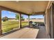 Enjoy outdoor dining on this covered patio, featuring a ceiling fan and view of the spacious backyard at 18822 E Flintlock Dr, Queen Creek, AZ 85142