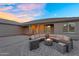 Outdoor oasis with fire pit, comfortable seating, and beautifully landscaped surroundings, perfect for entertaining guests at 18822 E Flintlock Dr, Queen Creek, AZ 85142