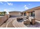 Inviting outdoor space with a fire pit, stylish seating, and paved patio, perfect for enjoying cozy evenings at 18822 E Flintlock Dr, Queen Creek, AZ 85142