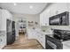 Well-lit white kitchen with dark stainless steel appliances at 18822 E Flintlock Dr, Queen Creek, AZ 85142