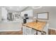 Bright kitchen with white cabinets and a butcher block table at 18822 E Flintlock Dr, Queen Creek, AZ 85142