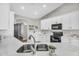 Well-lit kitchen featuring white cabinets, stainless steel appliances, and a stylish faucet at 18822 E Flintlock Dr, Queen Creek, AZ 85142