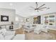 Bright living room with stylish furniture, seamlessly connects to dining area and outdoor patio at 18822 E Flintlock Dr, Queen Creek, AZ 85142
