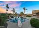 Inviting backyard pool with diving board and palm trees reflecting pink and blue sunset at 18822 E Flintlock Dr, Queen Creek, AZ 85142