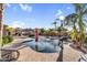 Beautiful swimming pool with lush landscaping, rock features, and desert foliage, creating a private resort atmosphere at 18822 E Flintlock Dr, Queen Creek, AZ 85142