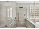 Modern glass enclosed shower with tiled walls, rainfall showerhead, and handrail at 18822 E Flintlock Dr, Queen Creek, AZ 85142